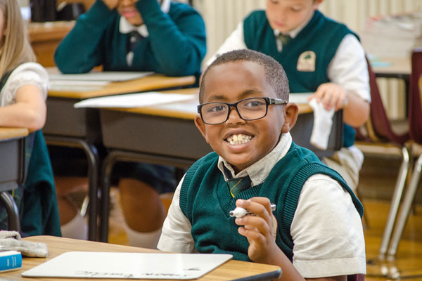 Oaks Academy lower school student at his desk
