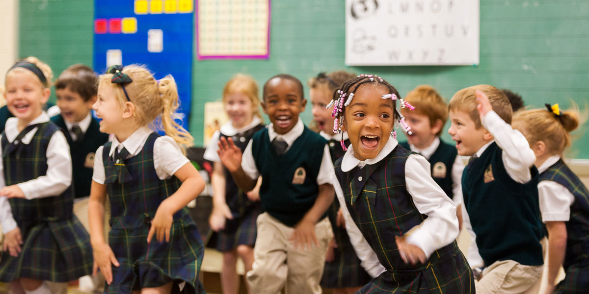 Pre-K students playing and smiling in class