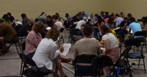 Teachers circle up to discuss during a professional development session