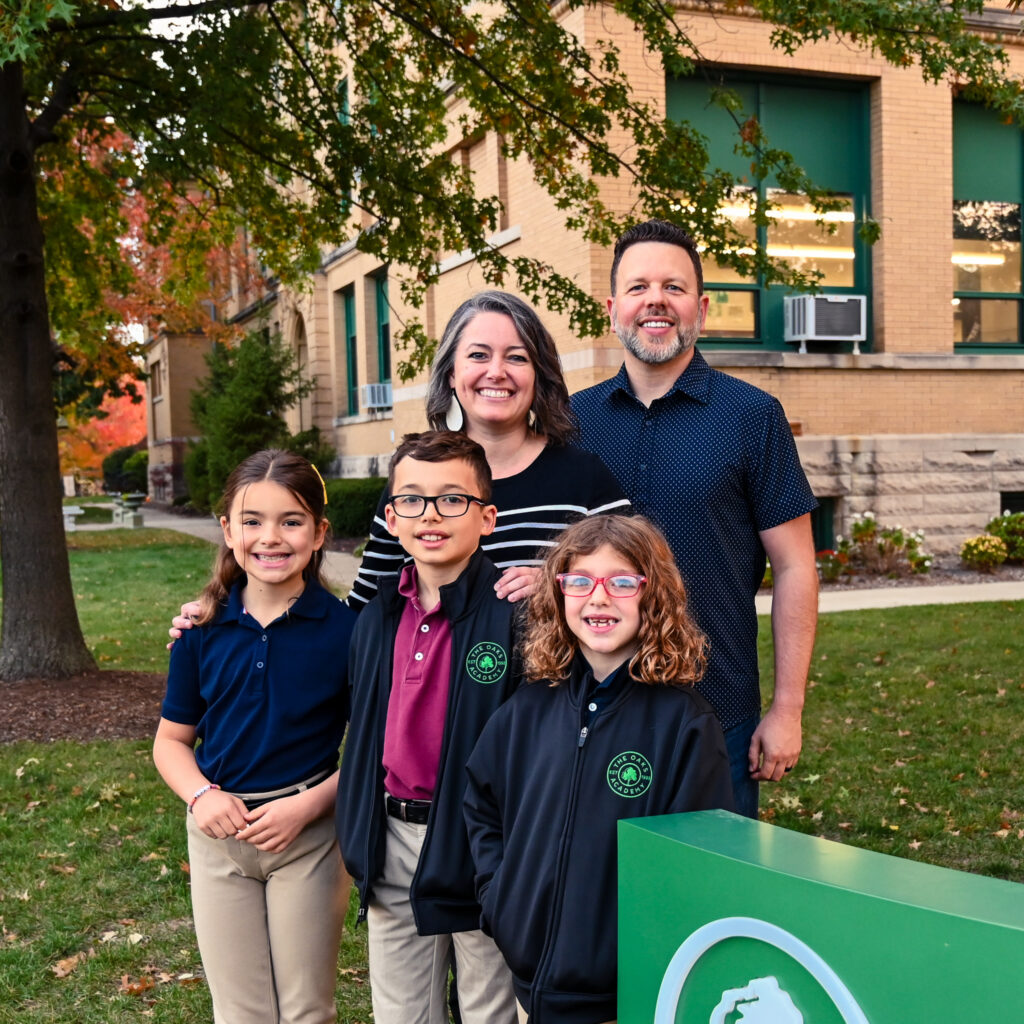 The Barbour family poses outside The Oaks Academy, Fall Creek