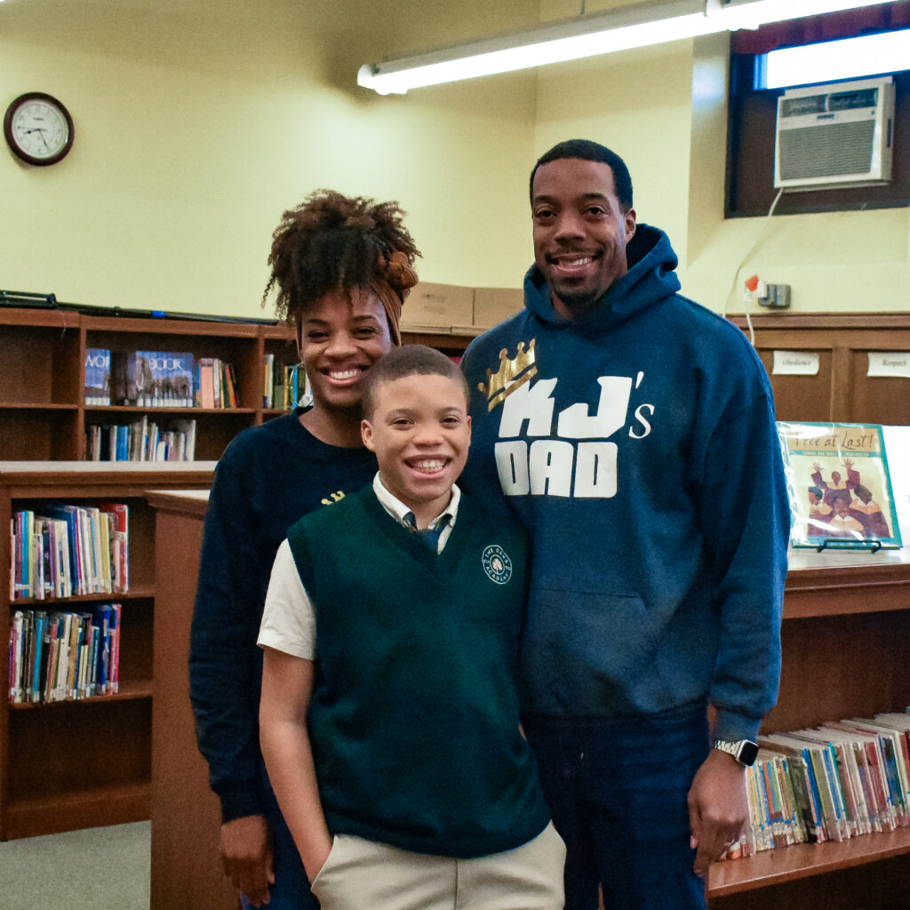 Kevin, Reggen and Josiah Melson stand together in the Brookside Campus library.
